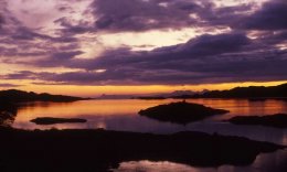 a dramatic sunset on the Small isles of Rum and Eigg, looking from Loch Ailort