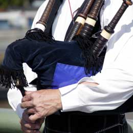 Image of you in a white top playing the bagpipes