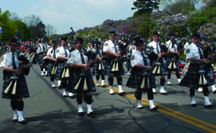authorities Pipe Band Marching in Kilts