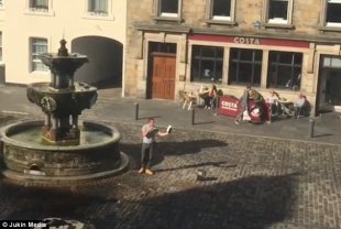 The hilarious incident happened in Scottish city of St Andrews when a hate preacher began ranting (pictured). He was caught on camera by one of those viewing the scene unfold from a nearby building