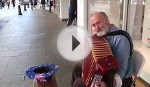 Busker plays Scottish reels on Accordion in Perth
