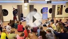 Donnie Nicolson playing bagpipes for Junior English School