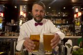 Rob Montgomery, supervisor of The Miller Tavern on Bay St., showcases two of his popular beer sizes, the successful Hour pint (a 20-ouncer) and the